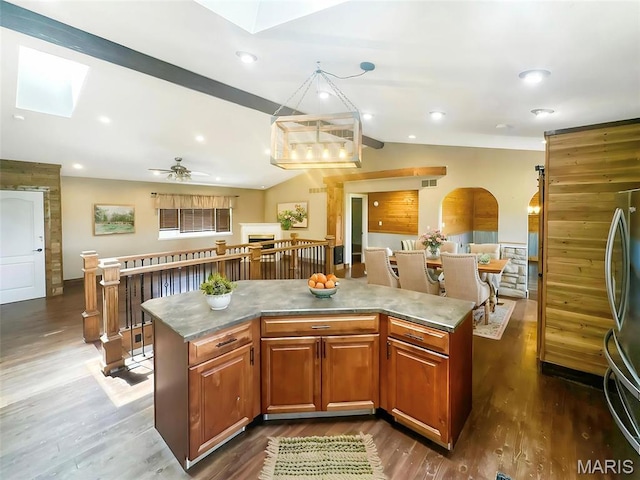 7203 Jakes Pr, Sullivan, MO 63080 - kitchen with a skylight, stainless steel refrigerator, vaulted ceiling, a center island, and dark wood finished floors