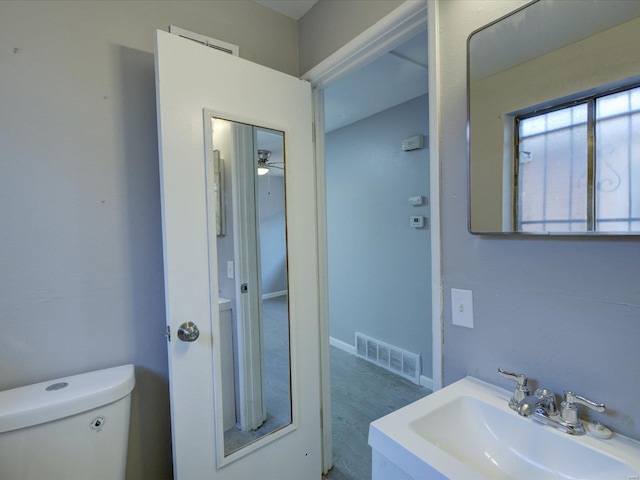 5555 Labadie, Saint Louis, MO 62120 - bathroom featuring a sink, toilet, ceiling fan, and wood finished floors