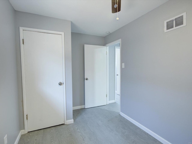 5555 Labadie, Saint Louis, MO 62120 - unfurnished bedroom featuring wood finished floors, baseboards, and ceiling fan