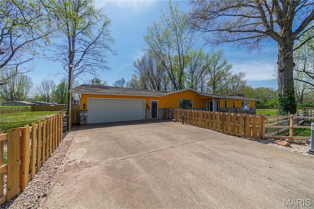 708 E Candy Cane Ln, West Frankfort, IL 62896 - view of front of property with stone siding, driveway, a garage, and a fenced front yard