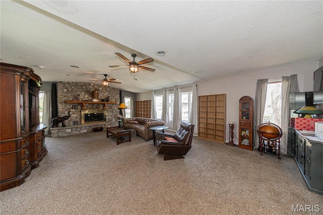 708 E Candy Cane Ln, West Frankfort, IL 62896 - living room featuring plenty of natural light, light colored carpet, ceiling fan, vaulted ceiling, and a fireplace