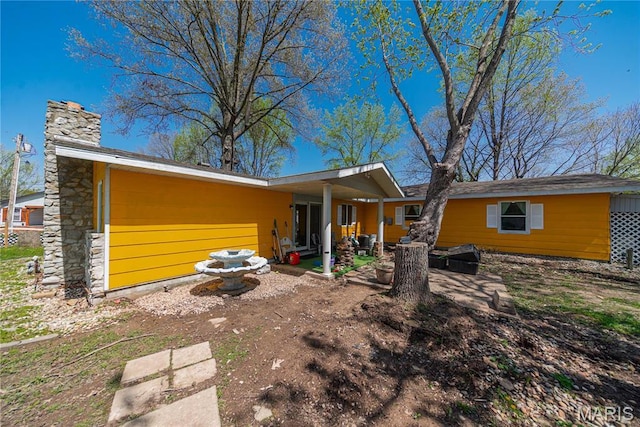 708 E Candy Cane Ln, West Frankfort, IL 62896 - rear view of property with an attached garage, a patio area, and a chimney