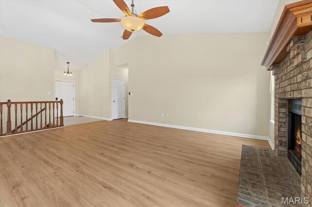 13374 Wintergreen Estates Dr, Fenton, MO 63026 - unfurnished living room with a brick fireplace, a ceiling fan, light wood-style floors, and high vaulted ceiling