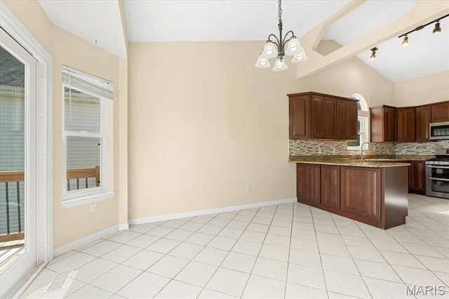 13374 Wintergreen Estates Dr, Fenton, MO 63026 - kitchen featuring stainless steel appliances, backsplash, a chandelier, track lighting, and plenty of natural light
