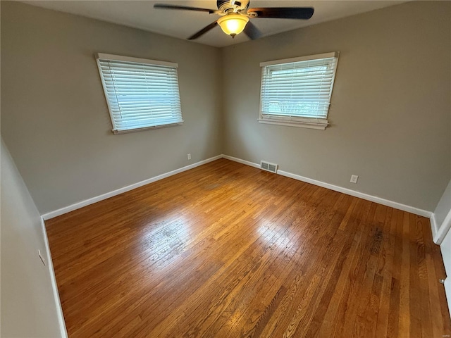 1418 Broadlawns Ln, Saint Louis, MO 63138 - spare room featuring wood finished floors, ceiling fan, and baseboards