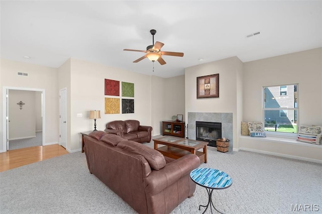 152 Geneva Cove Dr, Innsbrook, MO 63390 - carpeted living area featuring baseboards, ceiling fan, and a tile fireplace