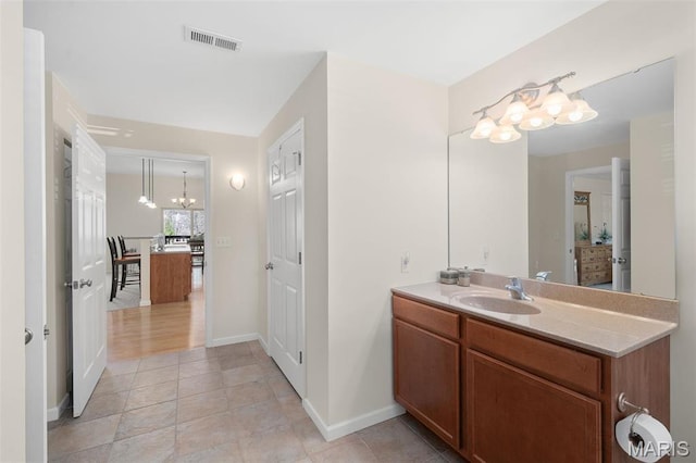 152 Geneva Cove Dr, Innsbrook, MO 63390 - bathroom with a chandelier, baseboards, and vanity