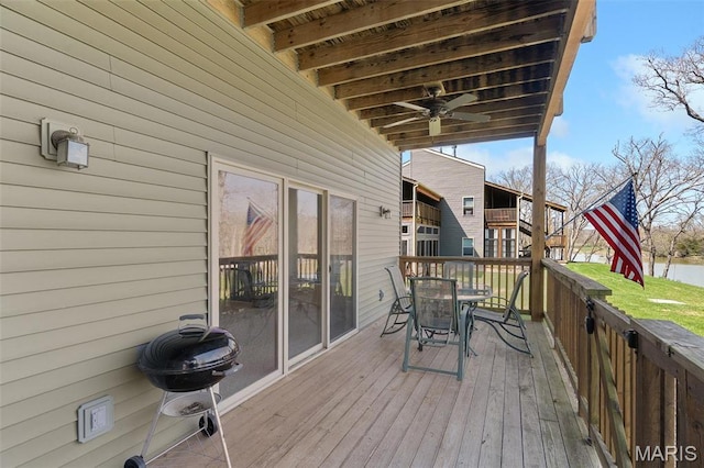 152 Geneva Cove Dr, Innsbrook, MO 63390 - wooden terrace featuring outdoor dining space, a grill, and a water view