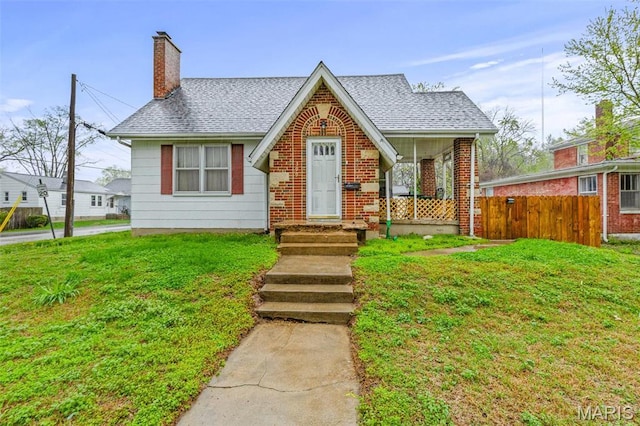 399 Roberts St, Saint Genevieve, MO 63670 - view of front of home featuring a chimney, a shingled roof, and brick siding