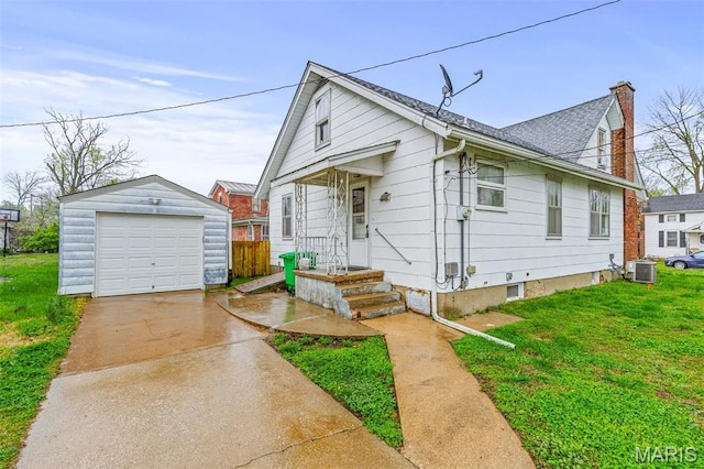 399 Roberts St, Saint Genevieve, MO 63670 - view of front of house featuring an outdoor structure, a detached garage, central air condition unit, a chimney, and concrete driveway