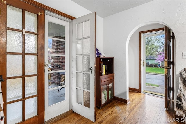 399 Roberts St, Saint Genevieve, MO 63670 - doorway to outside featuring arched walkways, wood-type flooring, and baseboards