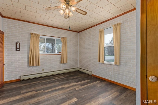 204 E 3rd N St, Mount Olive, IL 62069 - spare room featuring crown molding, plenty of natural light, baseboards, baseboard heating, and a ceiling fan