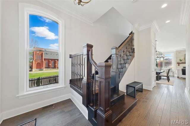 1212 Dolman St, Saint Louis, MO 63104 - stairs with a chandelier, wood finished floors, ornamental molding, baseboards, and recessed lighting