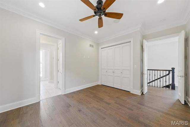 1212 Dolman St, Saint Louis, MO 63104 - unfurnished bedroom featuring wood finished floors, baseboards, recessed lighting, crown molding, and a closet