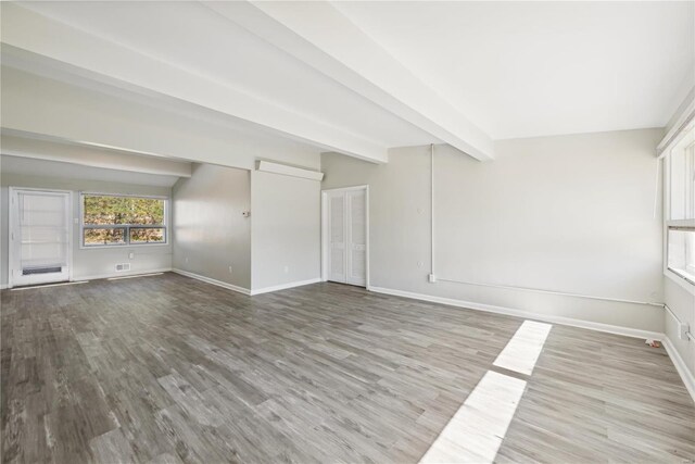 7921 Glenside Pl, Saint Louis, MO 63130 - unfurnished living room featuring wood finished floors, baseboards, and beamed ceiling