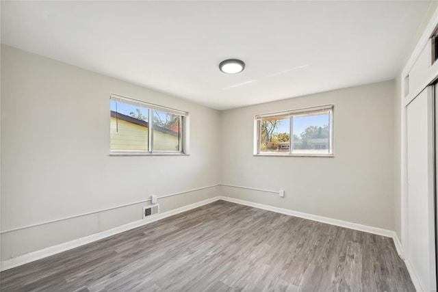 7921 Glenside Pl, Saint Louis, MO 63130 - unfurnished bedroom with wood finished floors, a closet, and baseboards