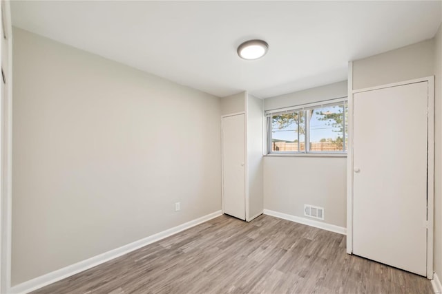 7921 Glenside Pl, Saint Louis, MO 63130 - unfurnished bedroom with light wood-style flooring, baseboards, and a closet