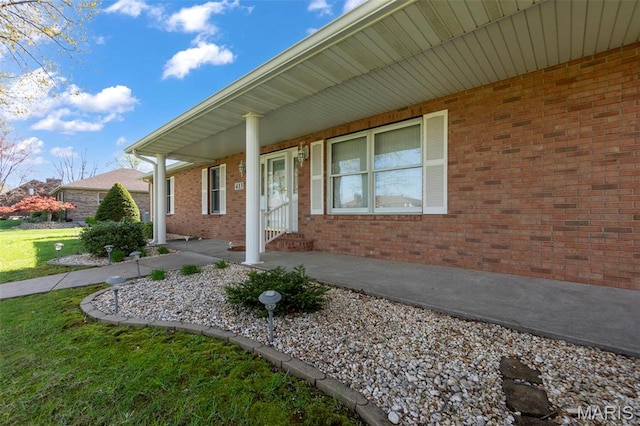 413 Huber Rd, Perryville, MO 63775 - doorway to property with covered porch, a lawn, and brick siding