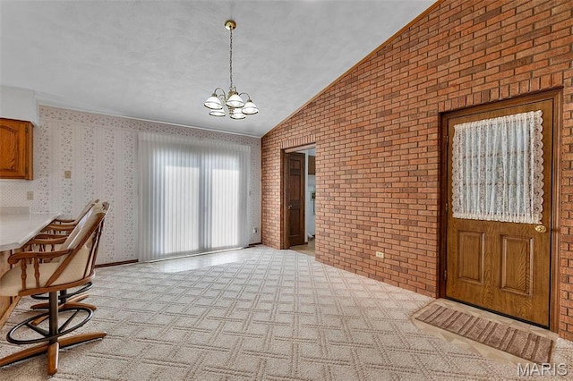 413 Huber Rd, Perryville, MO 63775 - dining space with brick wall, a chandelier, light colored carpet, and lofted ceiling