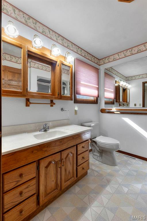 413 Huber Rd, Perryville, MO 63775 - bathroom featuring tile patterned floors, toilet, and vanity