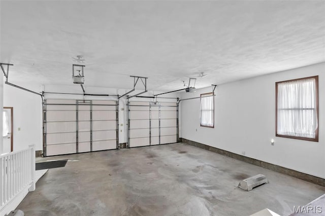 413 Huber Rd, Perryville, MO 63775 - garage featuring a garage door opener and baseboards