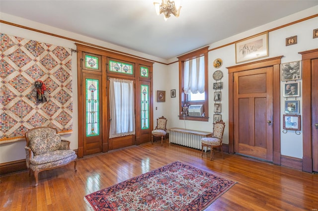entryway featuring radiator, wood finished floors, and cooling unit