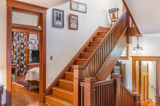 stairs featuring wood finished floors