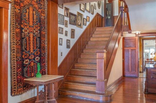 stairs featuring wood finished floors