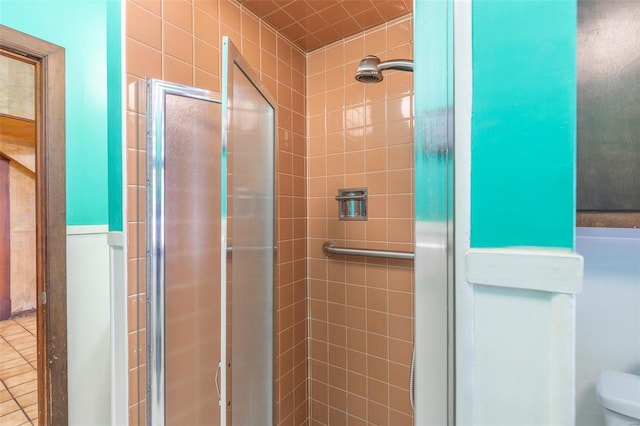 full bath with a stall shower and toilet