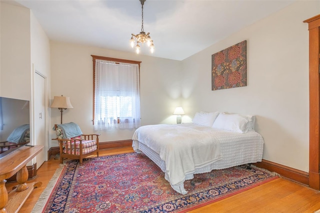 bedroom with wood finished floors and baseboards