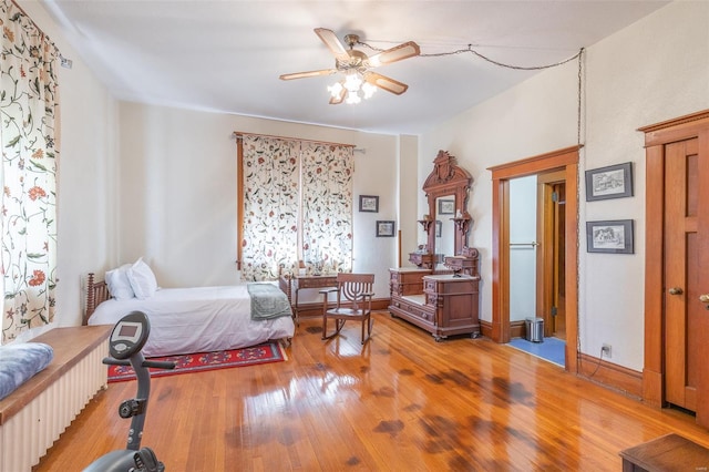 bedroom with light wood-style flooring and a ceiling fan