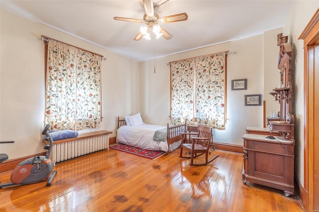 bedroom with hardwood / wood-style flooring and baseboards