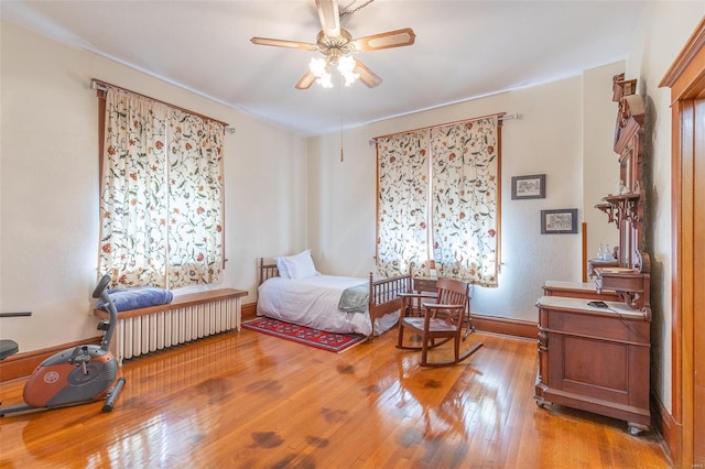 bedroom featuring hardwood / wood-style flooring, baseboards, and ceiling fan