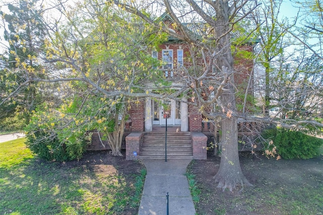 view of front facade with french doors and brick siding