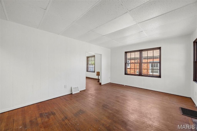 1825 S New Florissant Rd, Florissant, MO 63031 - empty room featuring hardwood / wood-style flooring, baseboards, and a paneled ceiling