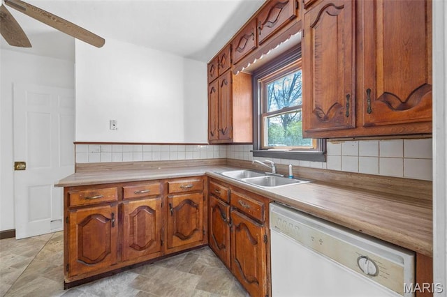 1825 S New Florissant Rd, Florissant, MO 63031 - kitchen with white dishwasher, a sink, backsplash, and brown cabinets