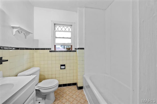 1825 S New Florissant Rd, Florissant, MO 63031 - bathroom featuring tile walls, toilet, a wainscoted wall, and vanity
