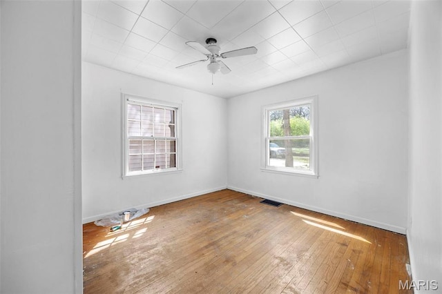 1825 S New Florissant Rd, Florissant, MO 63031 - empty room with hardwood / wood-style flooring, a ceiling fan, and baseboards