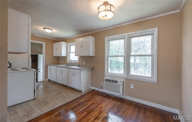 406 Locust St, Richland, MO 65556 - kitchen featuring range with electric cooktop, a sink, ornamental molding, a textured ceiling, and a wall mounted AC
