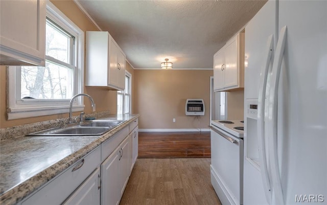 406 Locust St, Richland, MO 65556 - kitchen featuring white appliances, a sink, heating unit, light wood-type flooring, and white cabinets