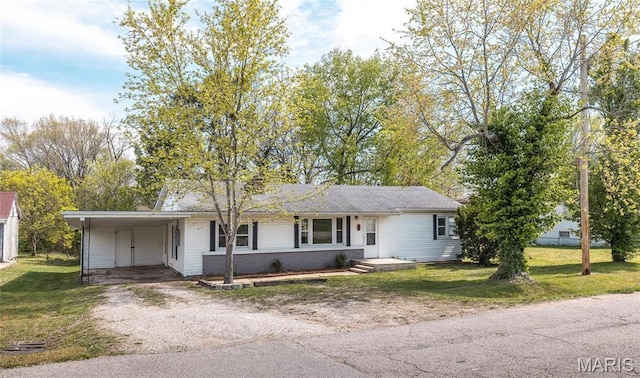 406 Locust St, Richland, MO 65556 - view of front of house with dirt driveway, a front yard, and a carport