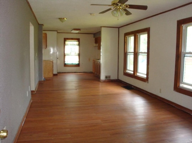 411 Southard Pl, South Roxana, IL 62087 - unfurnished living room featuring crown molding, healthy amount of natural light, light wood-style flooring, and a ceiling fan