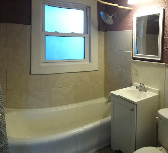 411 Southard Pl, South Roxana, IL 62087 - bathroom with tile walls, toilet, vanity, washtub / shower combination, and a textured wall