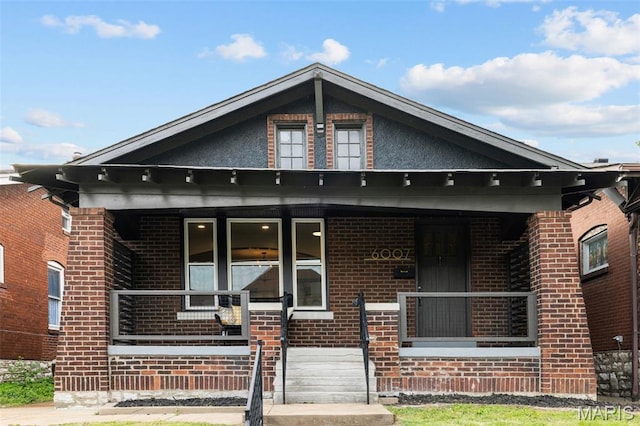 6007 S Kingshighway Blvd S, Saint Louis, MO 63109 - view of front facade featuring brick siding and a porch