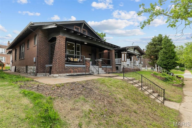 6007 S Kingshighway Blvd S, Saint Louis, MO 63109 - view of front of property featuring brick siding, covered porch, and a front yard
