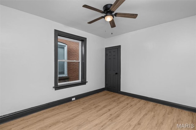 6007 S Kingshighway Blvd S, Saint Louis, MO 63109 - empty room with light wood-style flooring, baseboards, and a ceiling fan