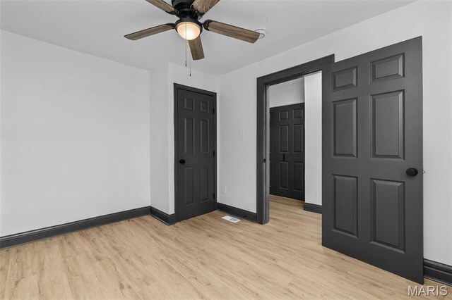 6007 S Kingshighway Blvd S, Saint Louis, MO 63109 - spare room featuring light wood-type flooring, baseboards, and a ceiling fan