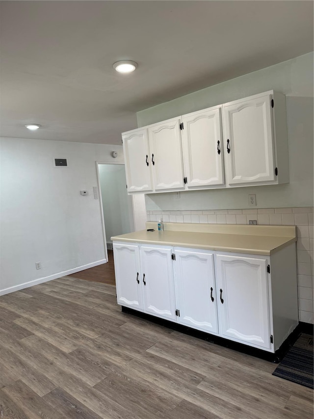 4400 Mohegan Dr, Saint Louis, MO 63123 - kitchen featuring white cabinetry, dark wood finished floors, light countertops, recessed lighting, and baseboards