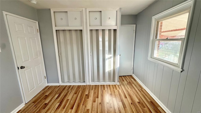 4400 Mohegan Dr, Saint Louis, MO 63123 - unfurnished bedroom featuring wood finished floors and baseboards
