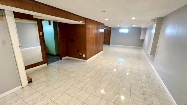 4400 Mohegan Dr, Saint Louis, MO 63123 - basement featuring baseboards, wood walls, and recessed lighting